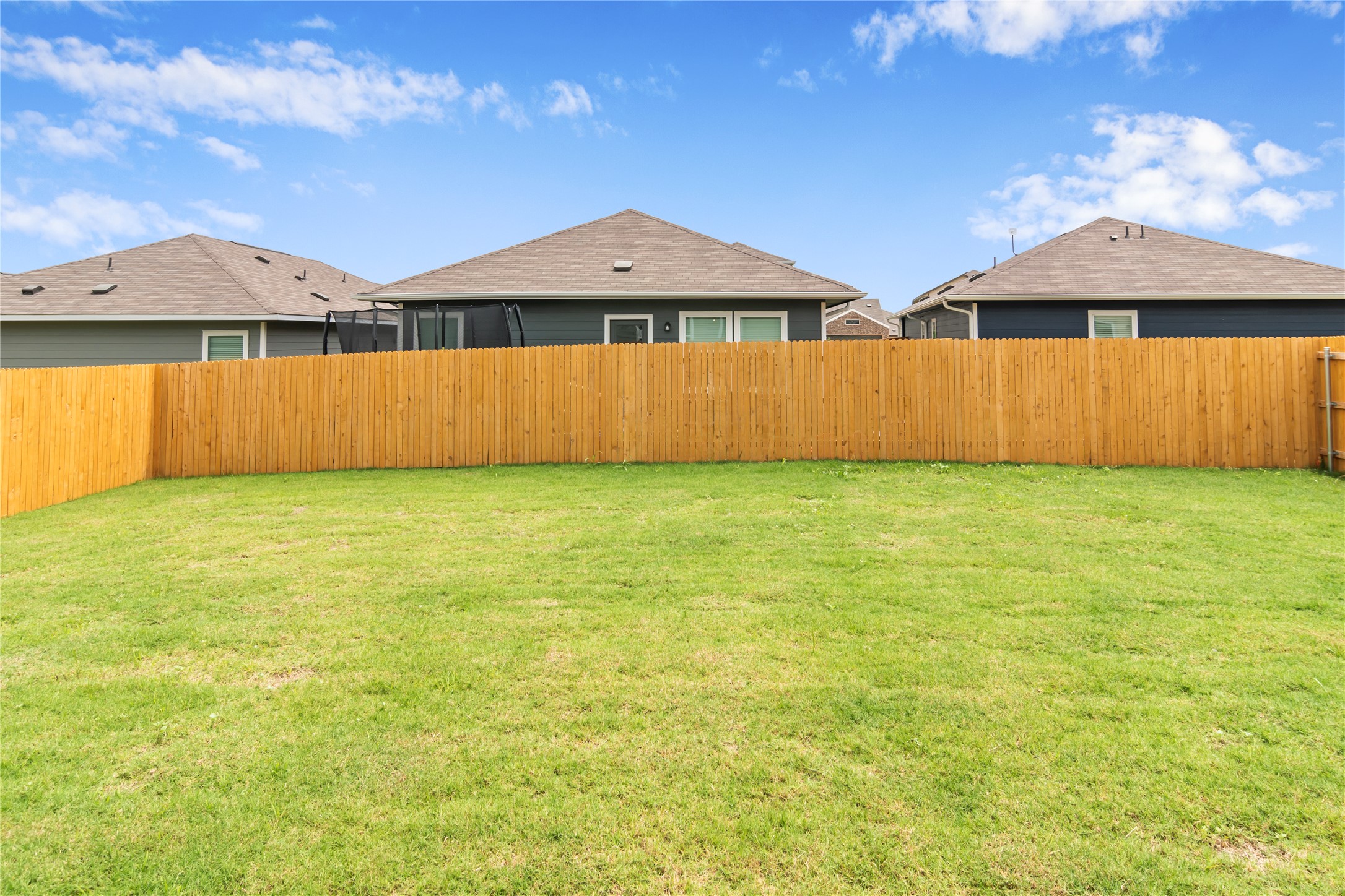112 Dollars Drive Jarrell, TX 76537 - Photo 24 of 27 a view of a house with a backyard and a tub