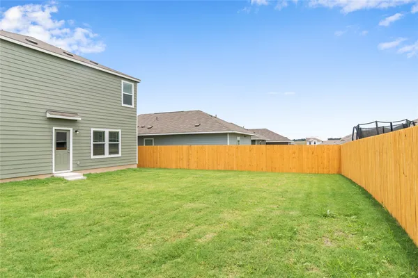 a view of a house with a backyard