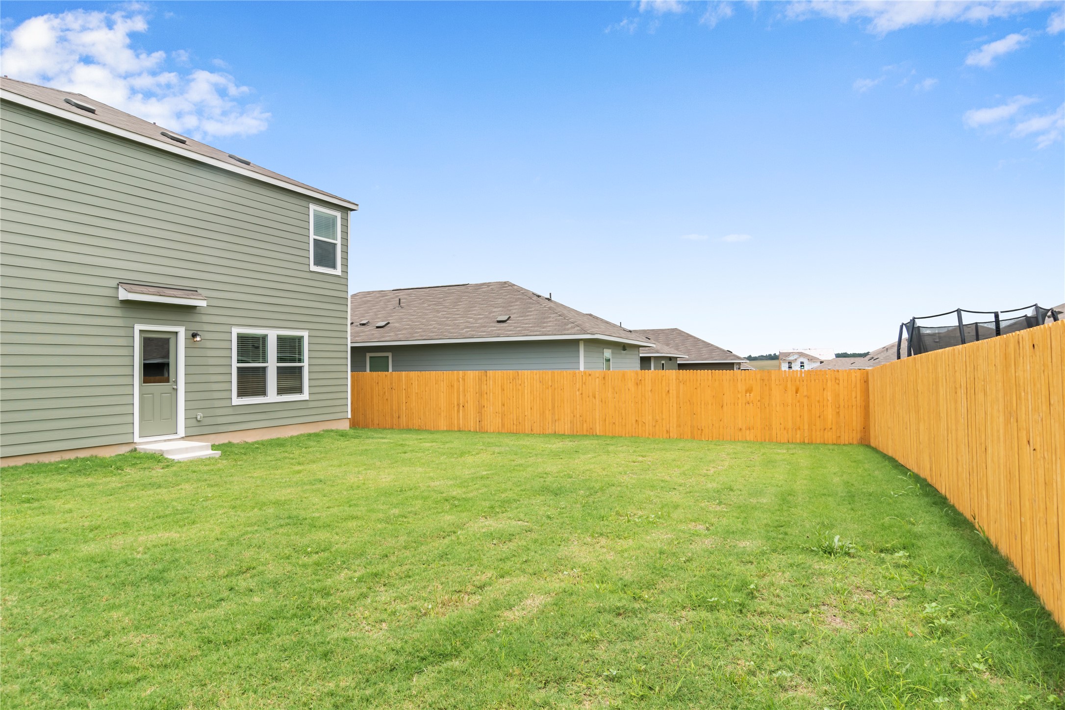 112 Dollars Drive Jarrell, TX 76537 - Photo 26 of 27 a view of a house with a yard and a large tree