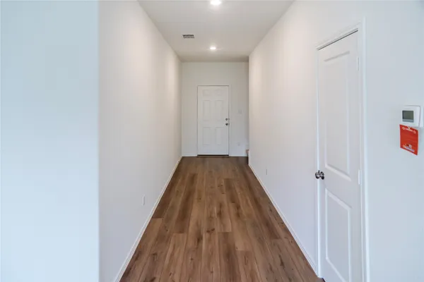 a view of wooden floor in a hallway