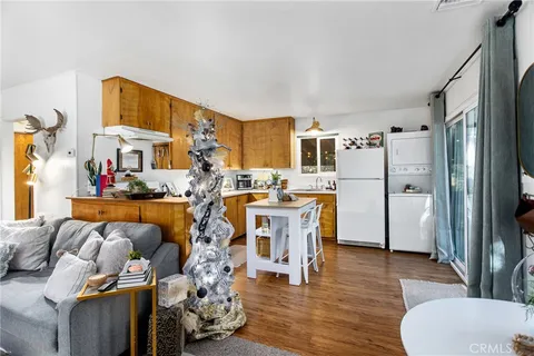 a living room with furniture and a kitchen view