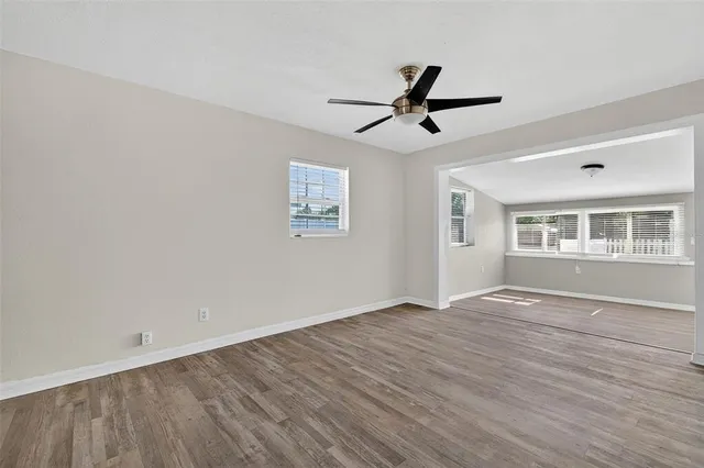 a view of a room with wooden floor and windows