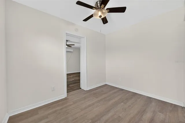 a view of an empty room with wooden floor