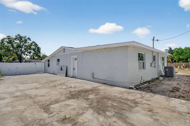 an aerial view of a swimming pool yard and mountain view in back