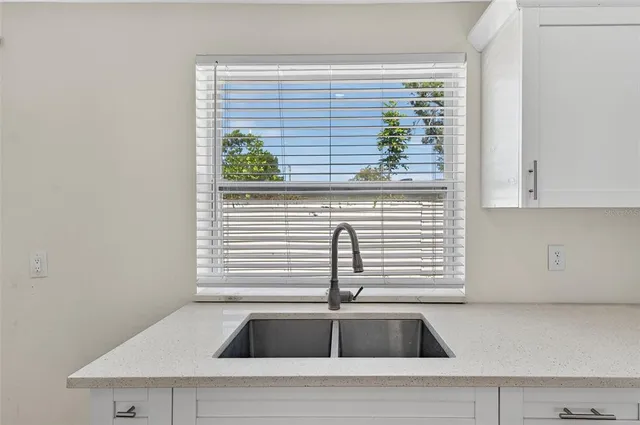 a kitchen with refrigerator and window