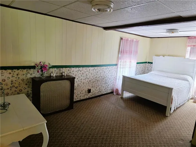 a bedroom with a bed and a couch