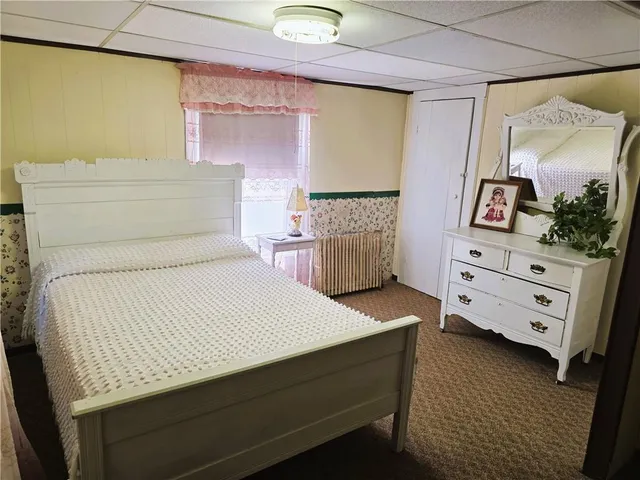 a bedroom with a bed and a dresser