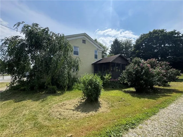 a view of a garden with a bench under an umbrella