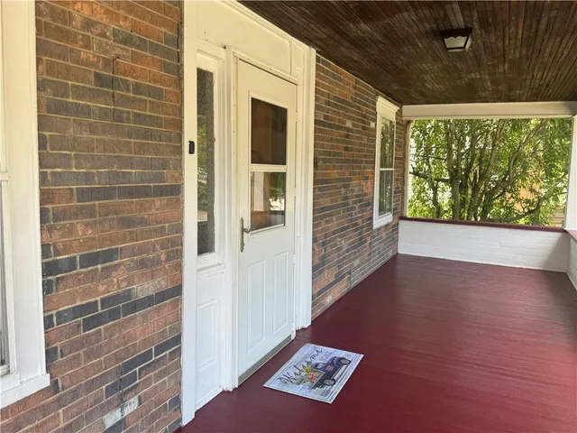 a view of an entryway with wooden floor