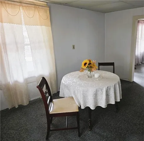 a bedroom with a bed a table and chair