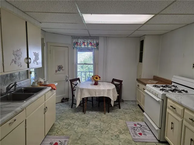 a kitchen that has a sink and a stove