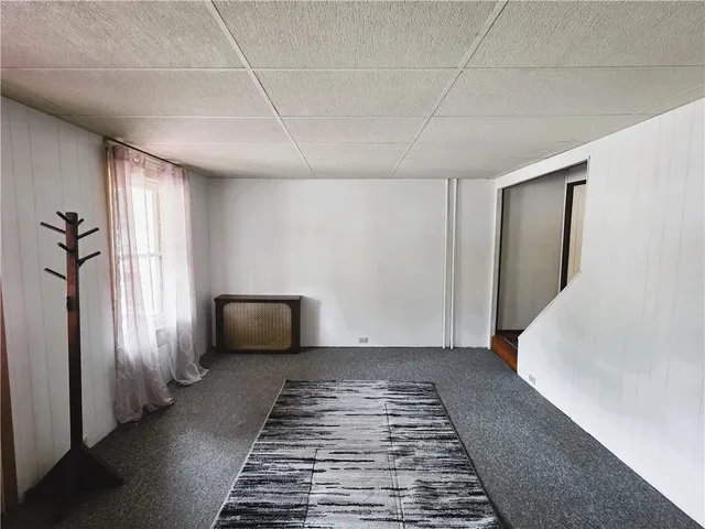 a hallway with windows and chandelier