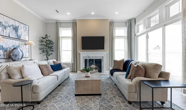 a living room with furniture fireplace and window