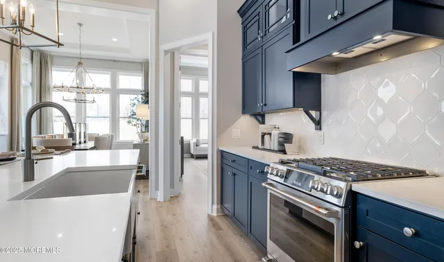 a kitchen with stainless steel appliances granite countertop a stove and a sink