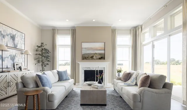 a living room with furniture fireplace and a large window
