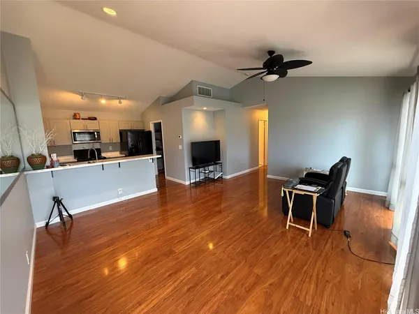 a view of a dining room with furniture and wooden floor