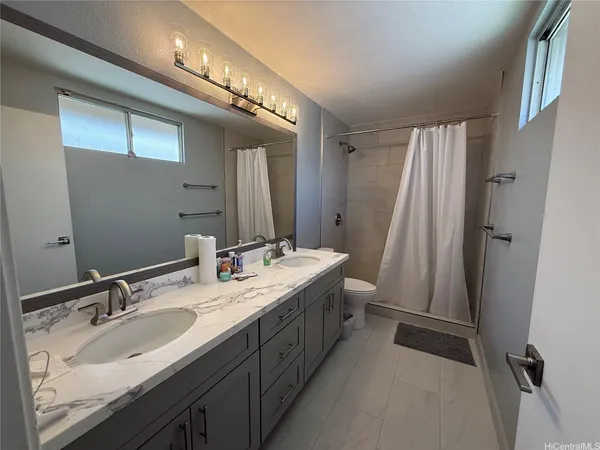 a bathroom with a double vanity sink and a mirror