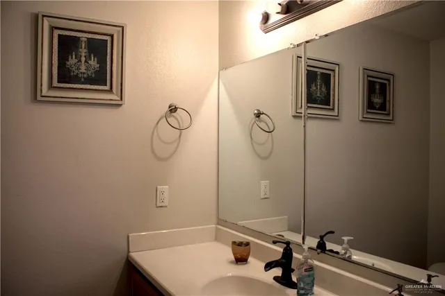 a bathroom with a sink and mirror