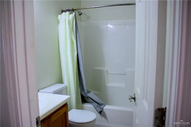a bathroom with a shower and a toilet