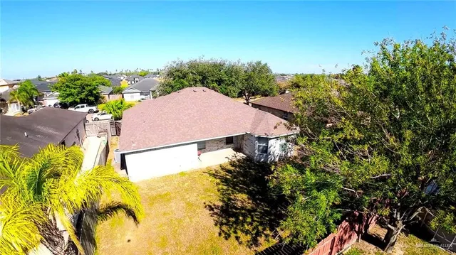an aerial view of a house with a yard swimming pool and lake view