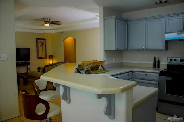a kitchen with a sink a stove and cabinets
