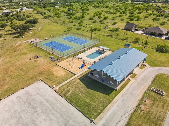 a view of a swimming pool with an outdoor seating and a yard