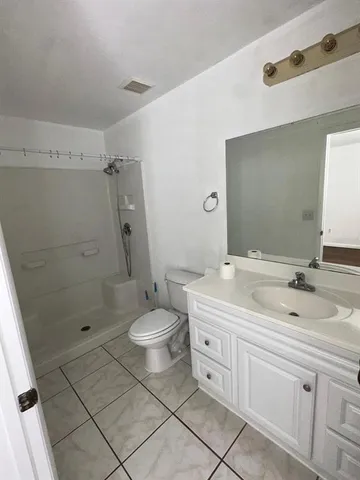 a bathroom with a double vanity sink toilet and shower