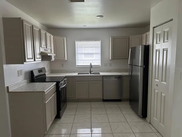 a kitchen with a sink a stove and refrigerator
