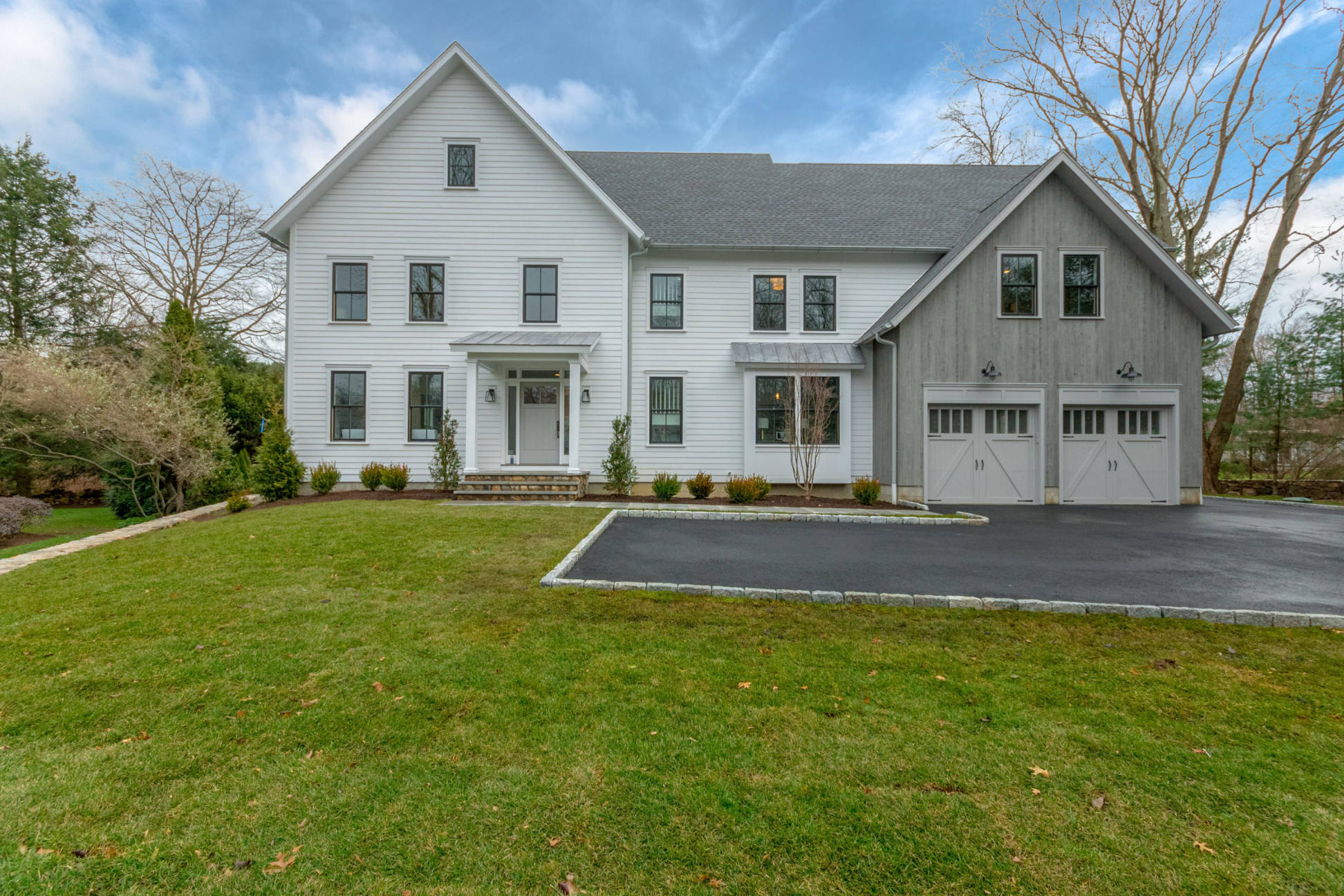 a view of a white house with a large pool
