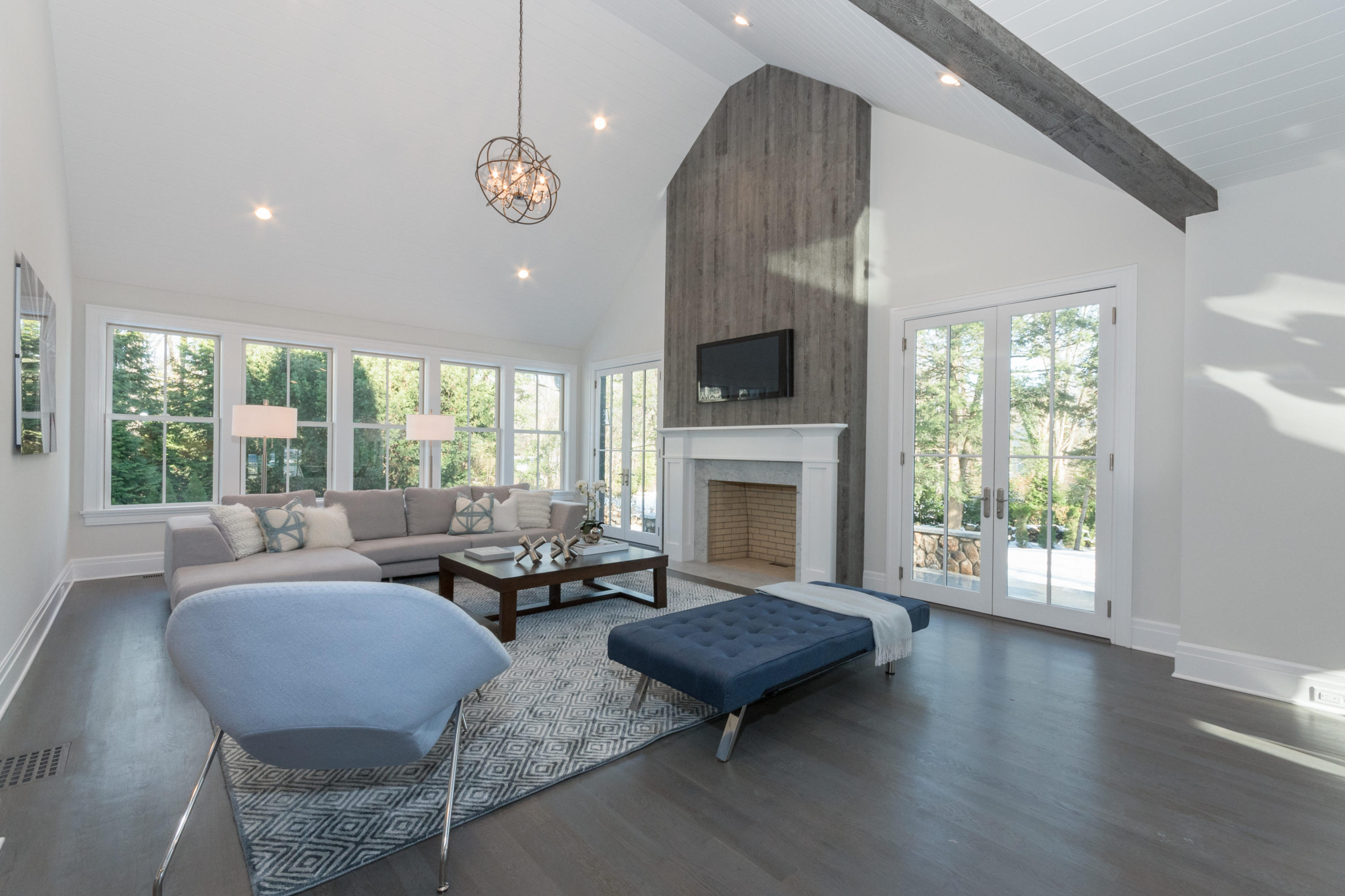7 Revere Road Darien, CT 06820 - Photo 12 of 45 a living room with furniture a fireplace and a floor to ceiling window