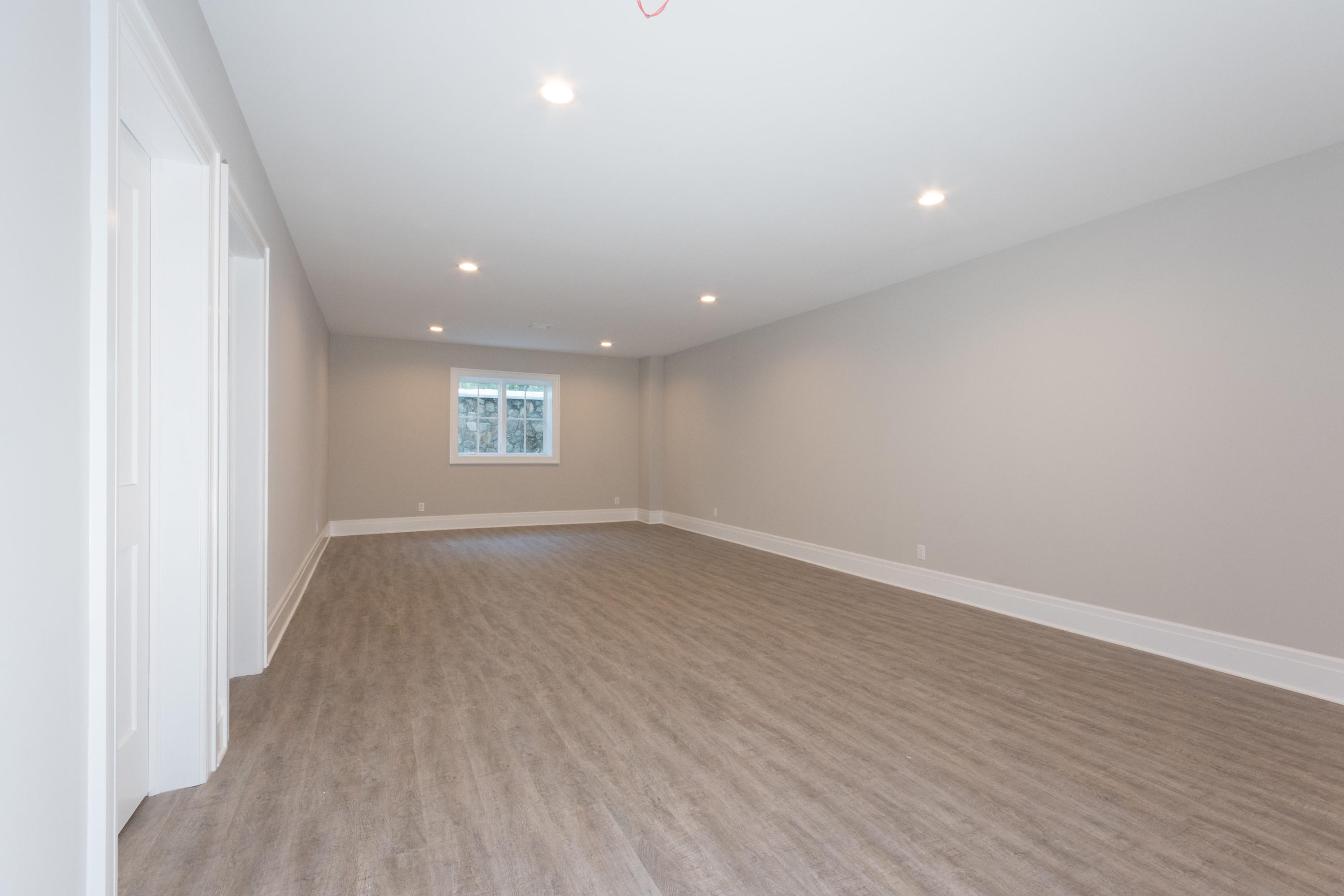 7 Revere Road Darien, CT 06820 - Photo 32 of 45 an empty room with wooden floor and window