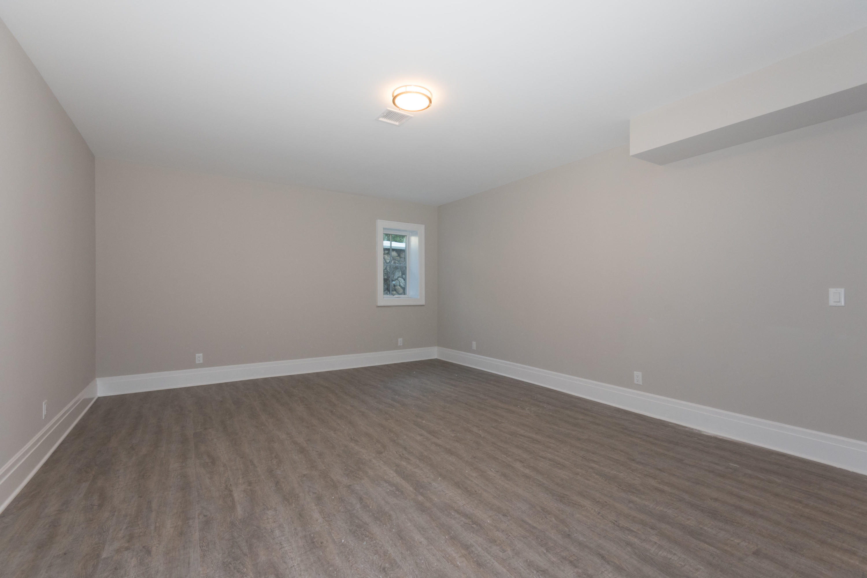 7 Revere Road Darien, CT 06820 - Photo 33 of 45 a view of an empty room with wooden floor and a window