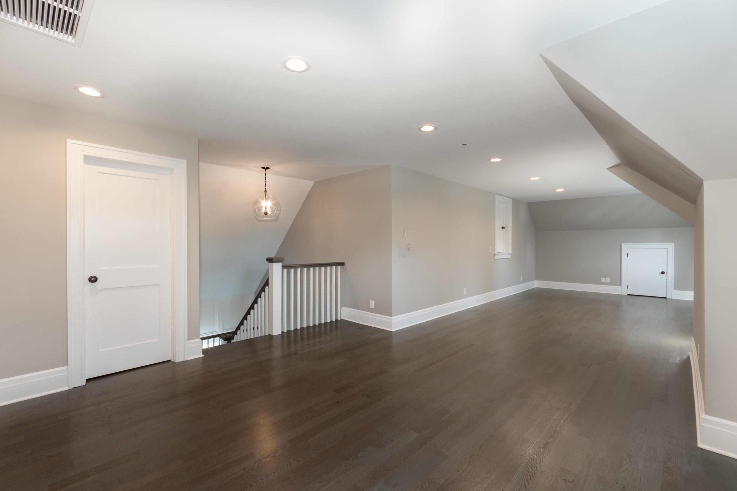 7 Revere Road Darien, CT 06820 - Photo 34 of 45 an empty room with wooden floor and stairs