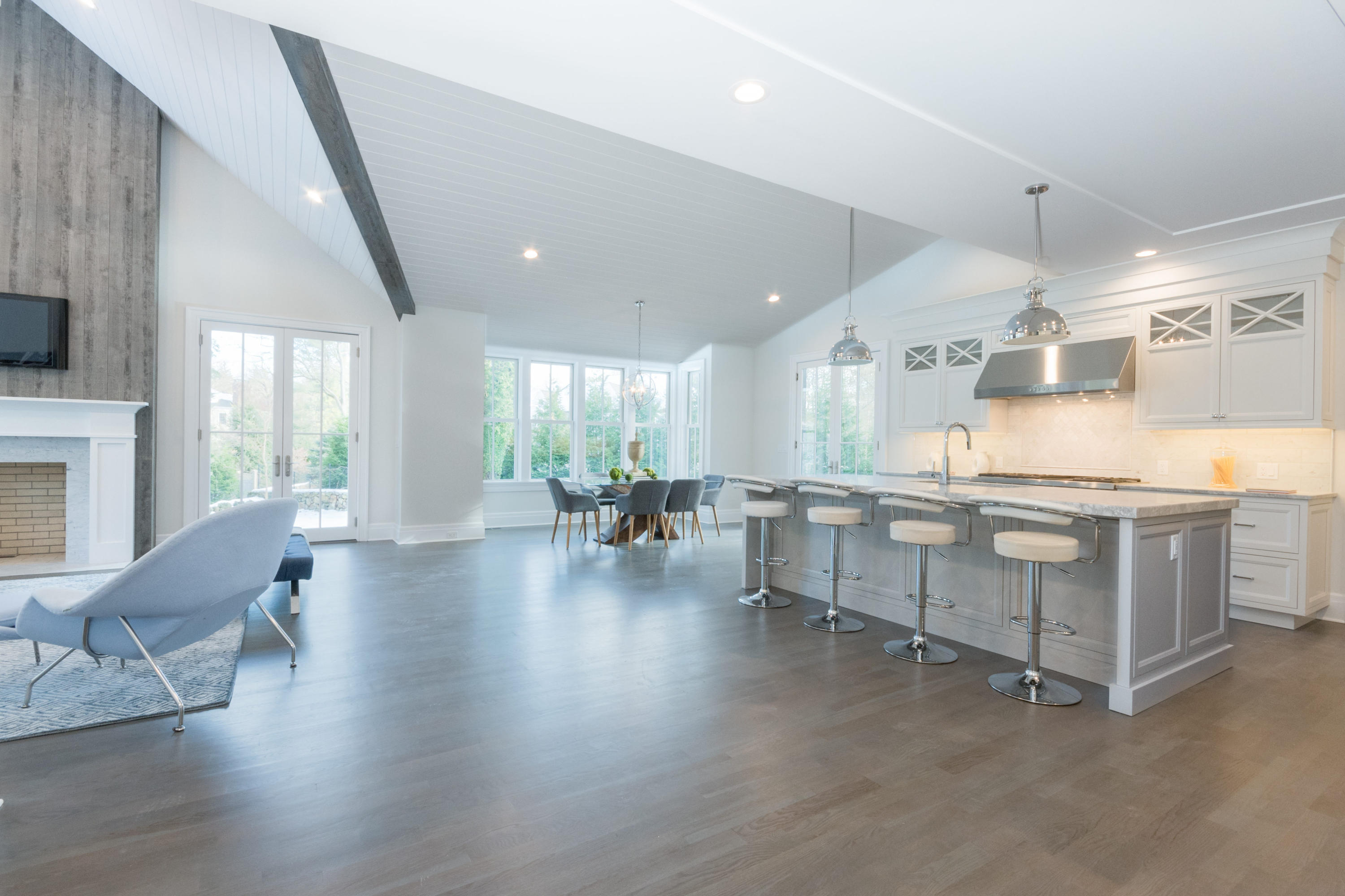 7 Revere Road Darien, CT 06820 - Photo 10 of 45 a large white kitchen with lots of counter space a sink and chairs