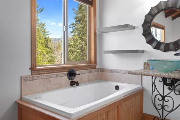 a white bath tub sitting next to a window