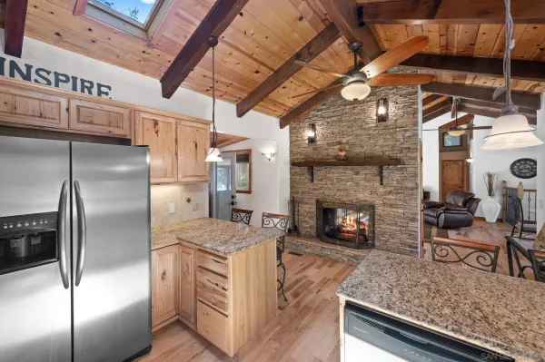 a kitchen with stainless steel appliances granite countertop a sink a stove and a refrigerator