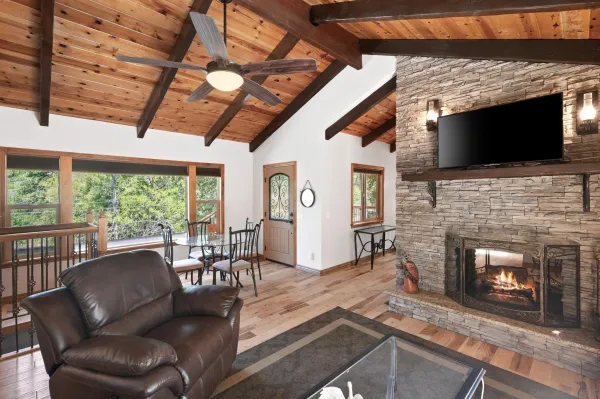 a living room with furniture a flat screen tv and a fireplace