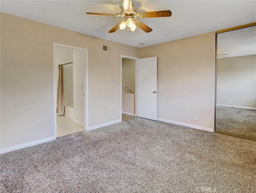 1881 Mitchell Avenue, Unit 63 Tustin, CA 92780 - Photo 20 of 24 a view of an empty room and chandelier fan