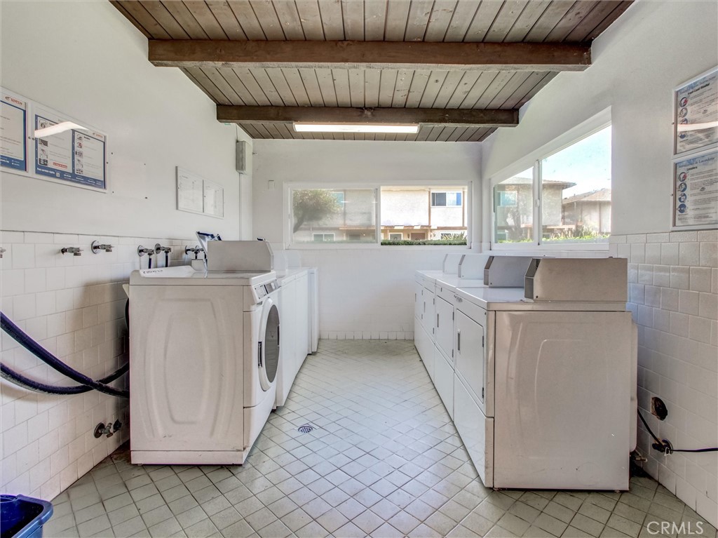 1881 Mitchell Avenue, Unit 63 Tustin, CA 92780 - Photo 24 of 24 a kitchen with white cabinets and white appliances