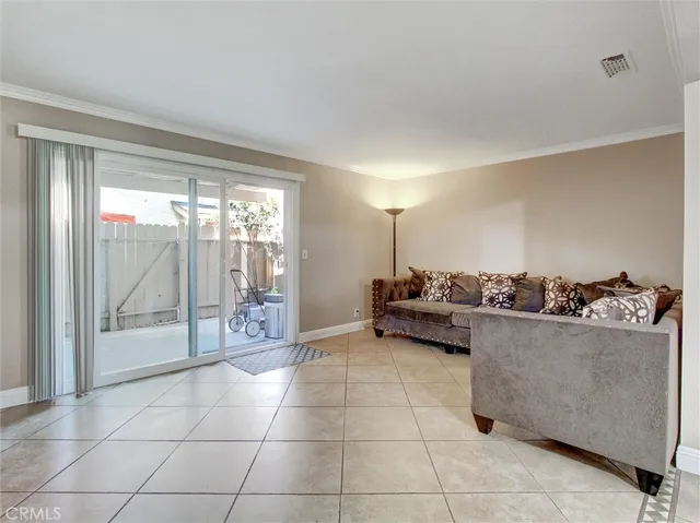 a living room with furniture and a floor to ceiling window