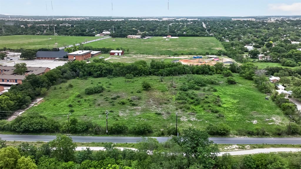 1328 Holbrook Road San Antonio, TX 78218 - Photo 4 of 21 a view of a lush green field with lots of green plants and trees in the background
