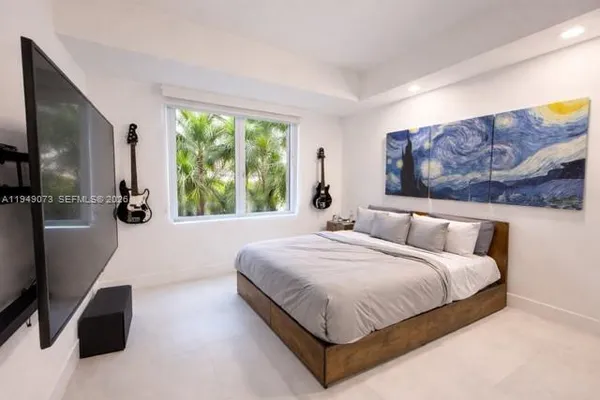 a bedroom with a large bed and a large window