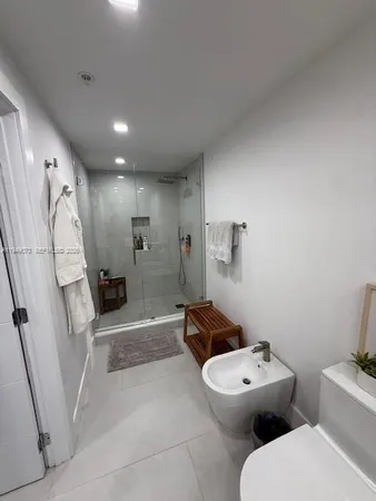 a bathroom with a toilet sink and shower