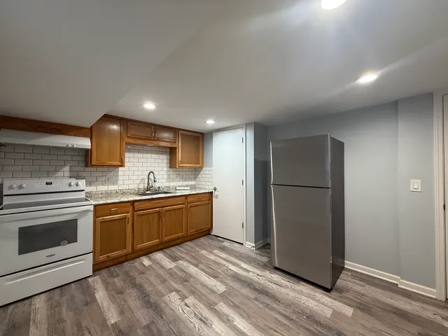 a large kitchen with a stove and a refrigerator