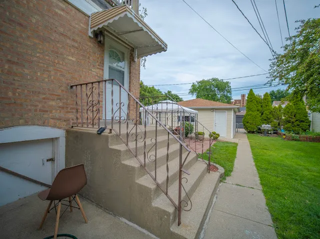 a view of a chair and table in the garden