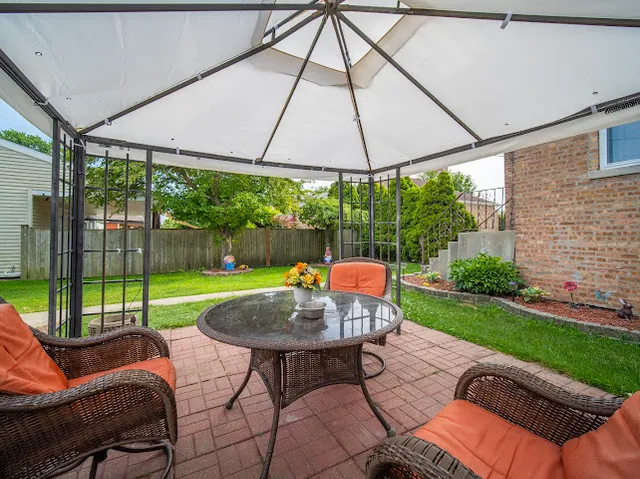 a view of backyard with furniture and garden