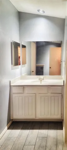 a bathroom with a sink a mirror and a vanity