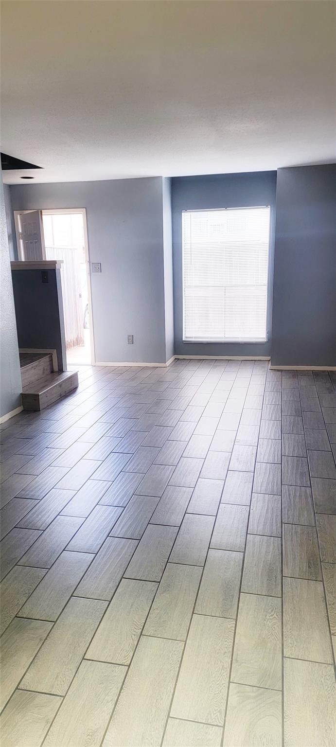 2110 Wilcrest Drive, Unit 113 Houston, TX 77077 - Photo 18 of 22 a view of a livingroom with an empty space and a window