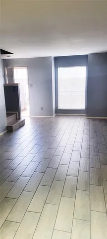 a view of a livingroom with an empty space and a window