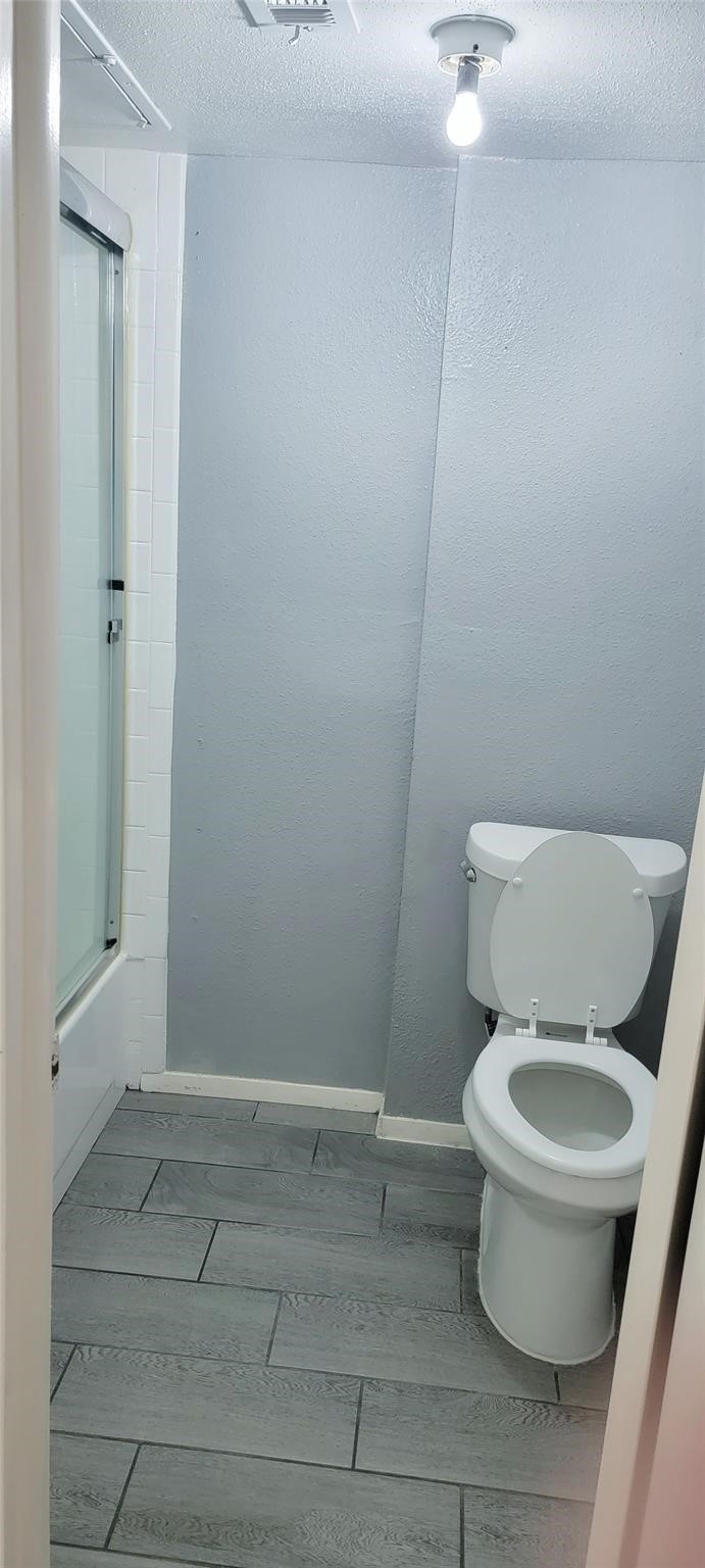 2110 Wilcrest Drive, Unit 113 Houston, TX 77077 - Photo 20 of 22 a white toilet sitting next to a shower